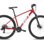 VTT BH Spike 1.0 rouge en situation sur un chemin de terre.